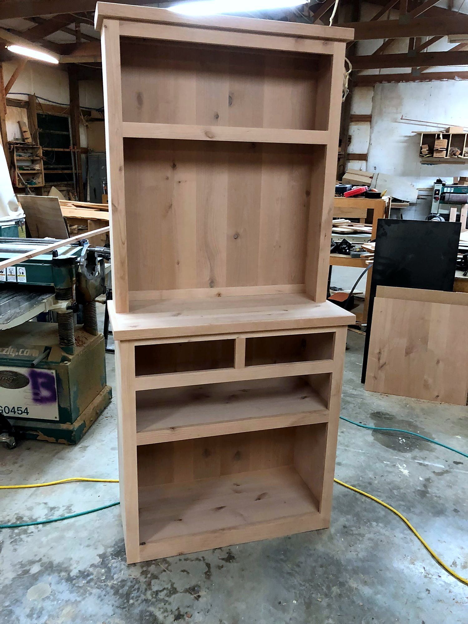 Open hutch cabinet with two upper display shelves and a row of narrow lower cubbies, natural knotty alder, unstained in the shop