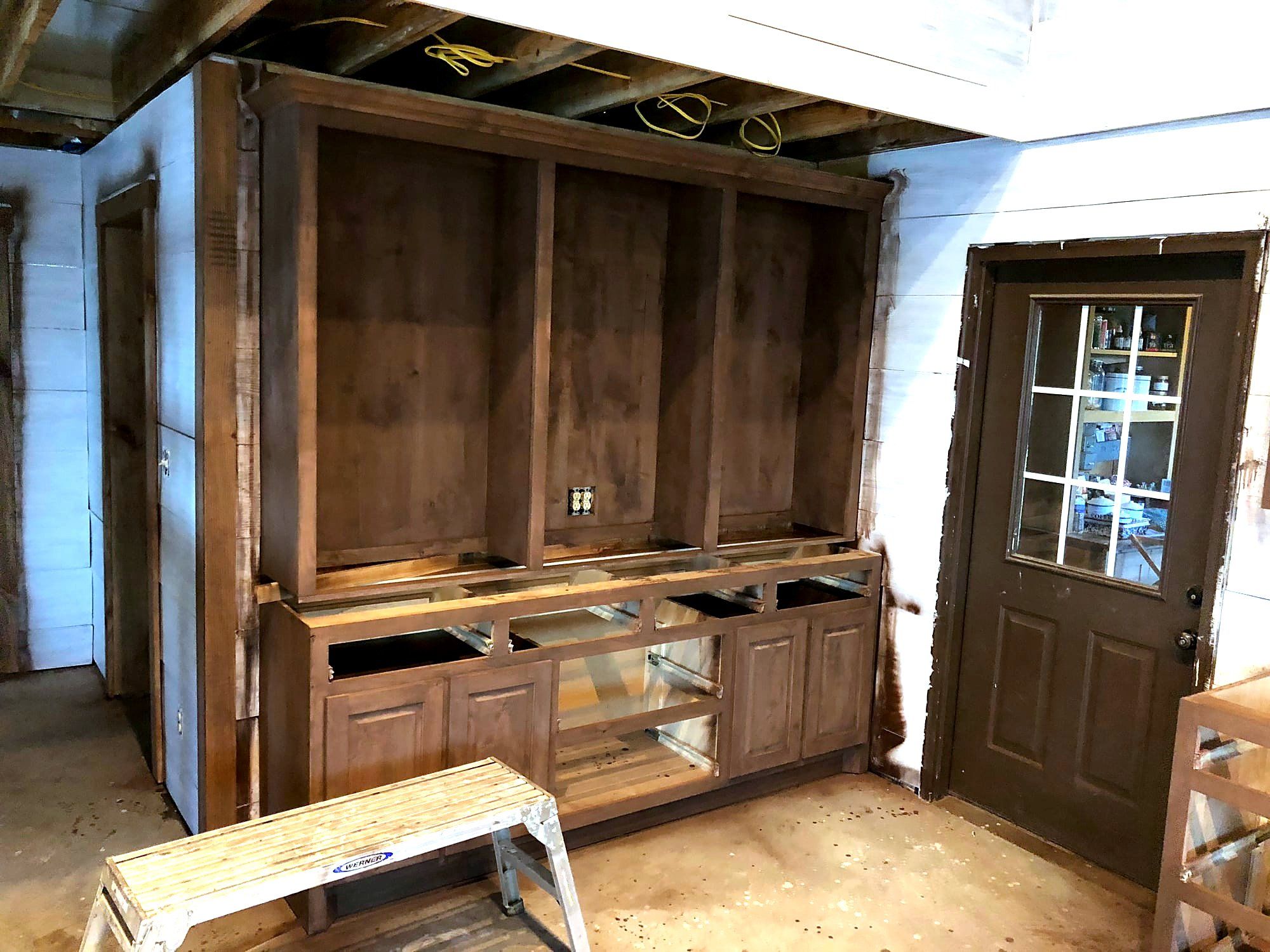 Built-in wood media cabinet with glass display doors and open shelving