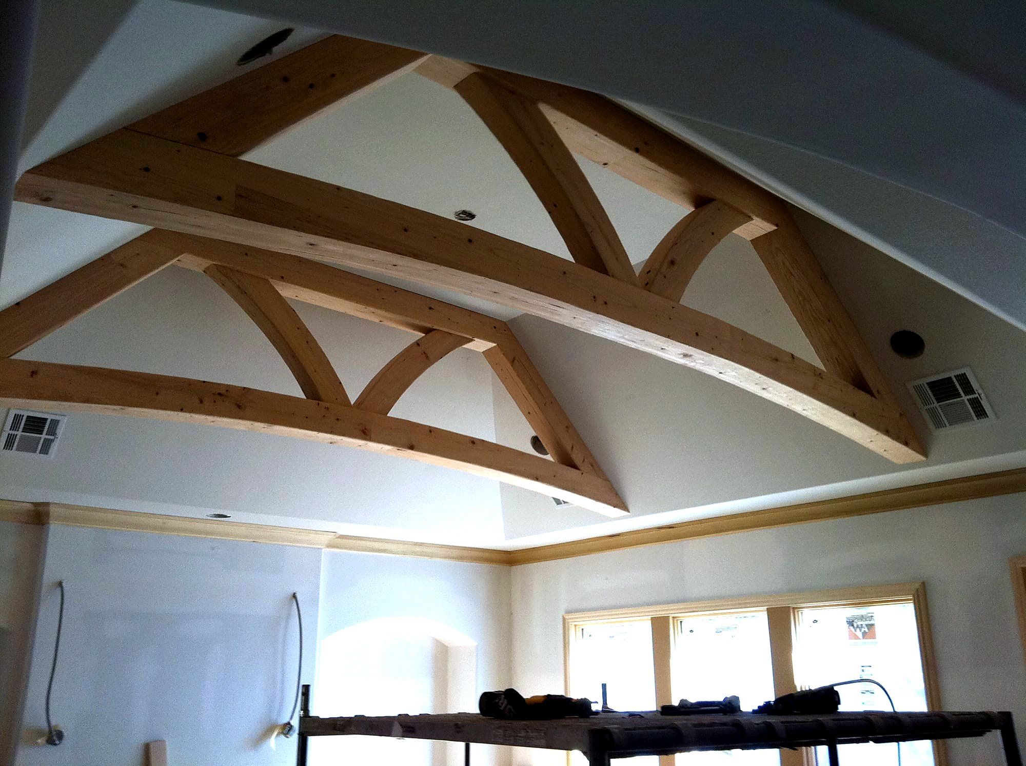 Vaulted room with an exposed wood truss ceiling and painted walls