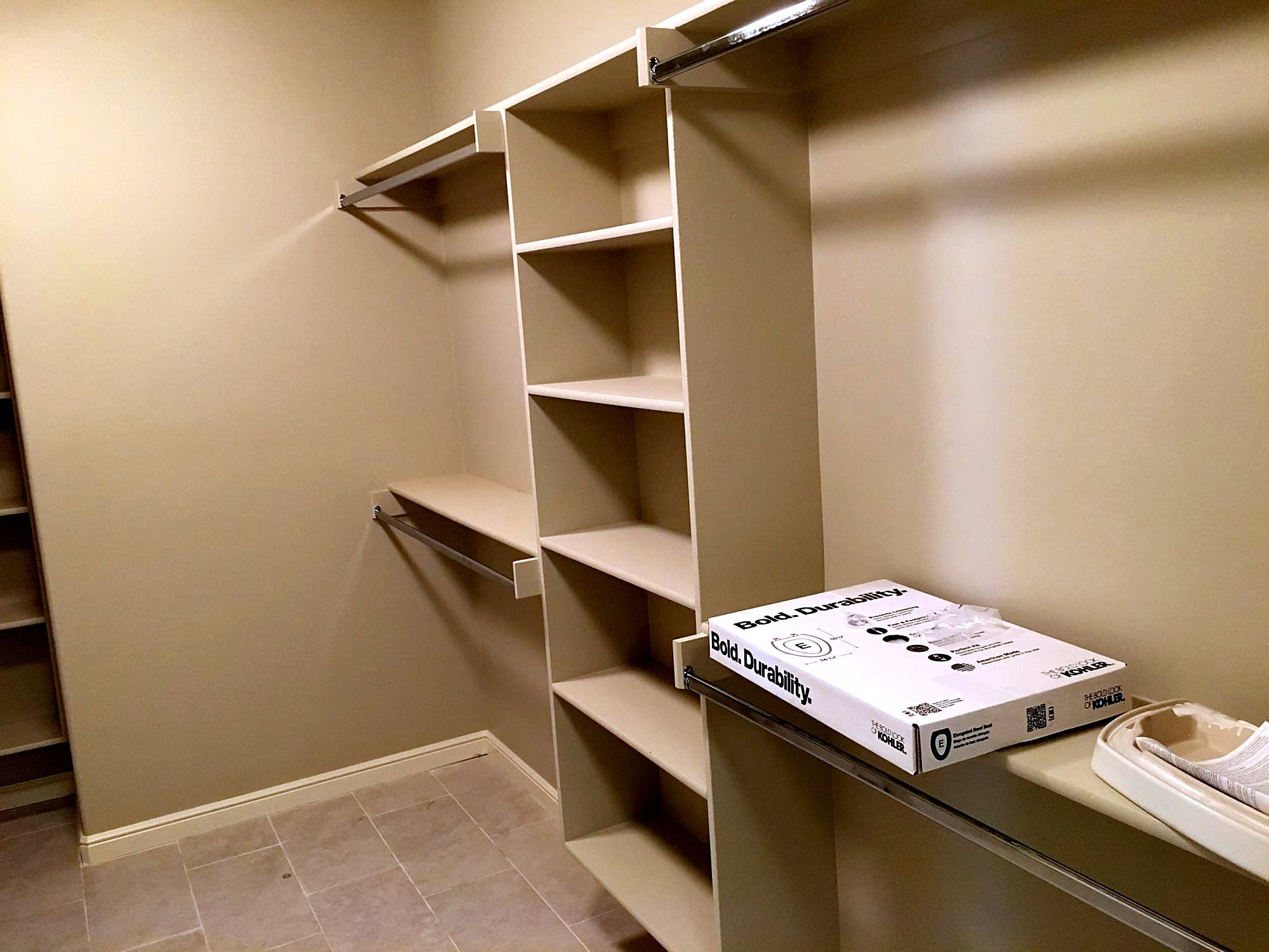 Built-in closet shelving system with adjustable shelves and hanging rods